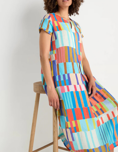 woman wearing bright coloured print linen midi dress