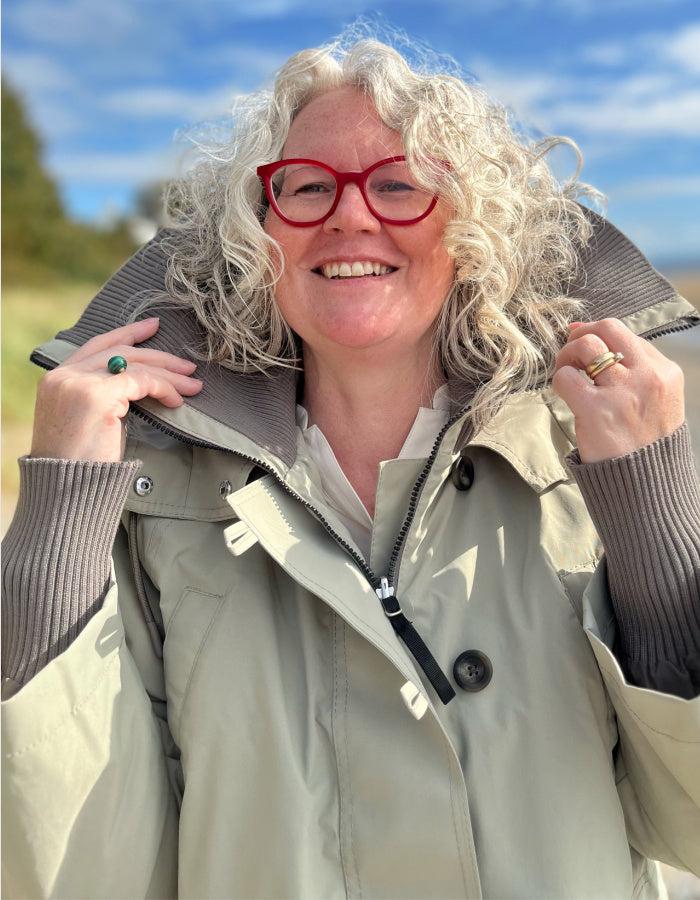 waterproof beige parka coat with hood and ribbed cuffs and stand up collar