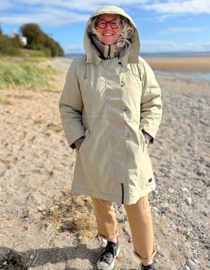 waterproof beige parka coat with hood and ribbed cuffs and stand up collar