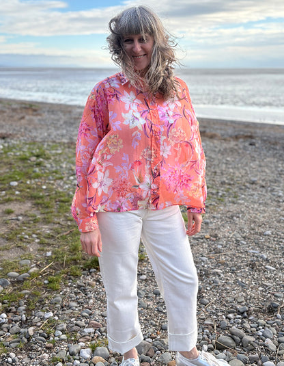 cream jeans with a peach and cream floral cotton blouse