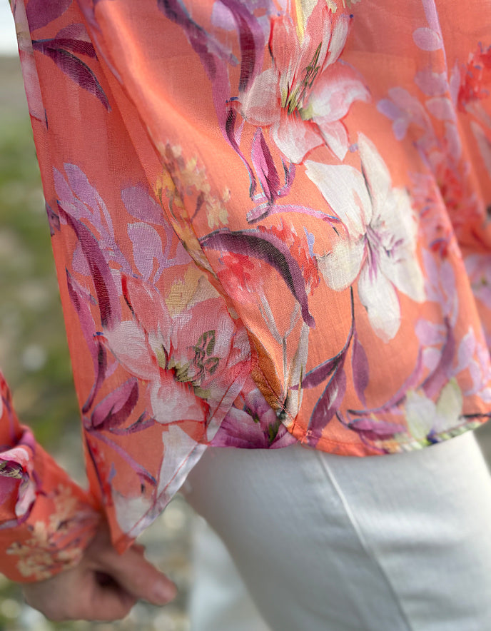 cream jeans with a peach and cream floral cotton blouse