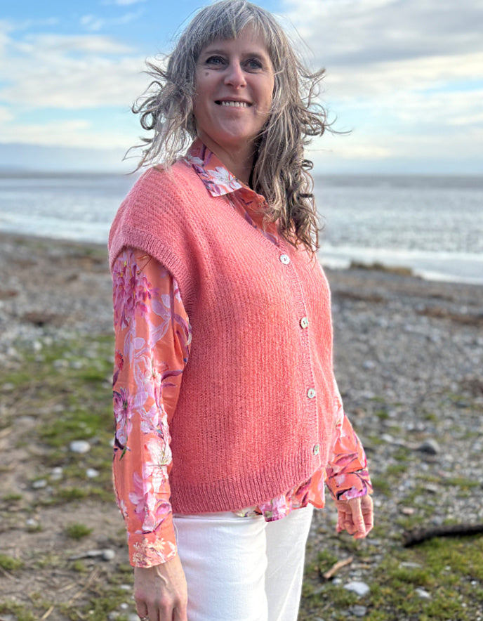 knitted wool tank waistcoat worn over a floral cotton blouse in peach and pink florals