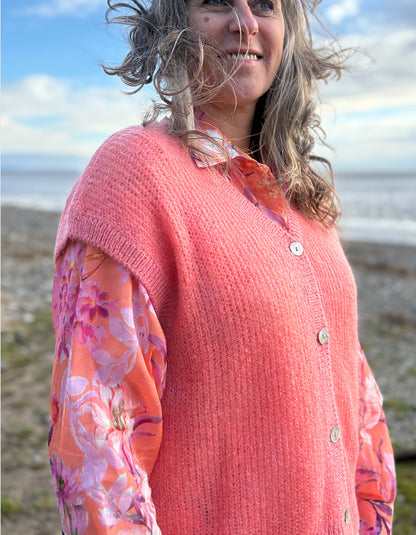 knitted wool tank waistcoat worn over a floral cotton blouse in peach and pink florals