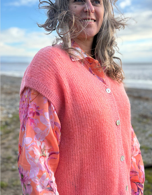 knitted wool tank waistcoat worn over a floral cotton blouse in peach and pink florals