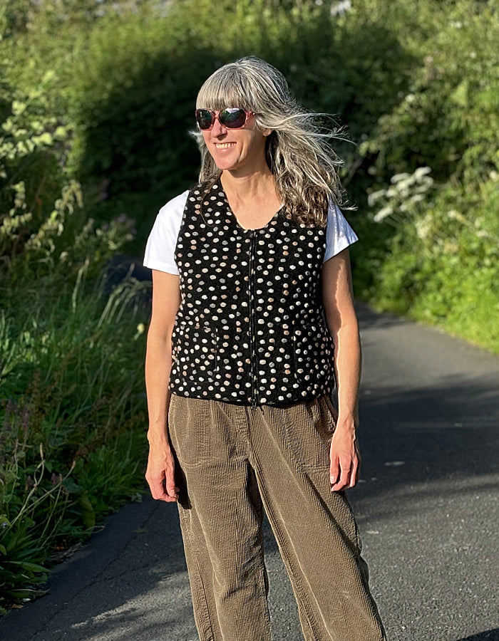 black boiled wool zip up vest with neutral felted pebble details