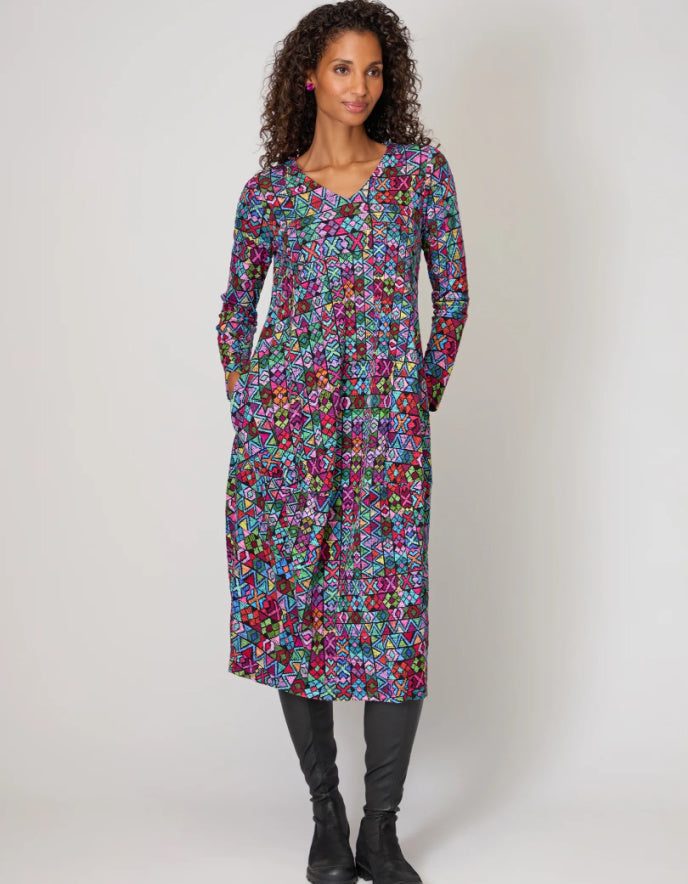 Woman wearing a colorful floral dress on a white background