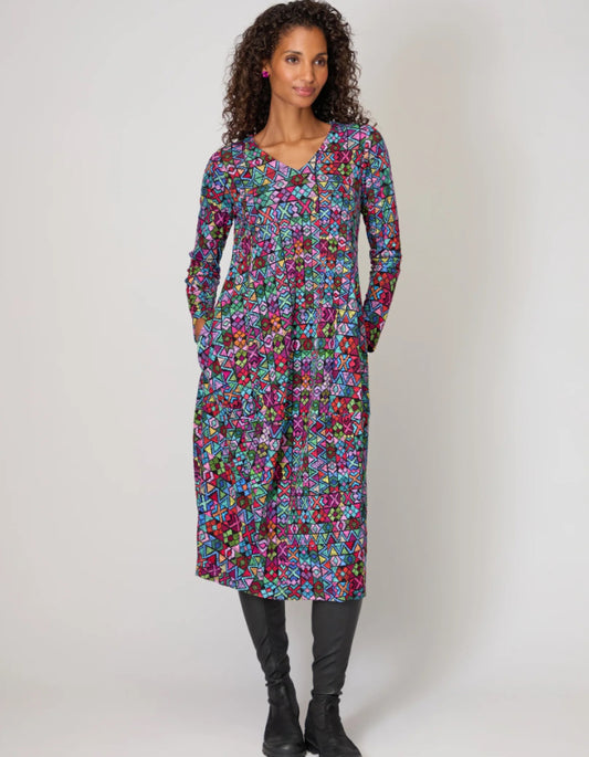Woman wearing a colorful floral dress on a white background