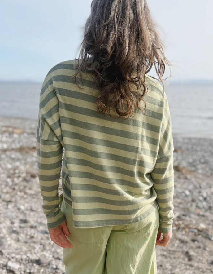 woman wearing striped green and yellow cardigan with soft green trousers