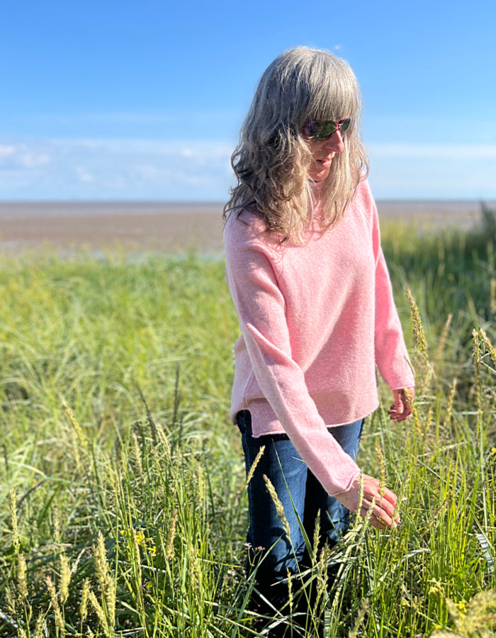 soft pink wool sweater with oversized fit and raglan sleeves and floppy turtle neck