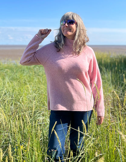 soft pink wool sweater with oversized fit and raglan sleeves and floppy turtle neck