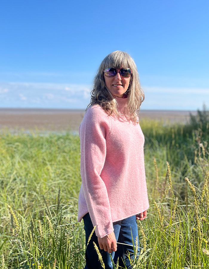 soft pink wool sweater with oversized fit and raglan sleeves and floppy turtle neck