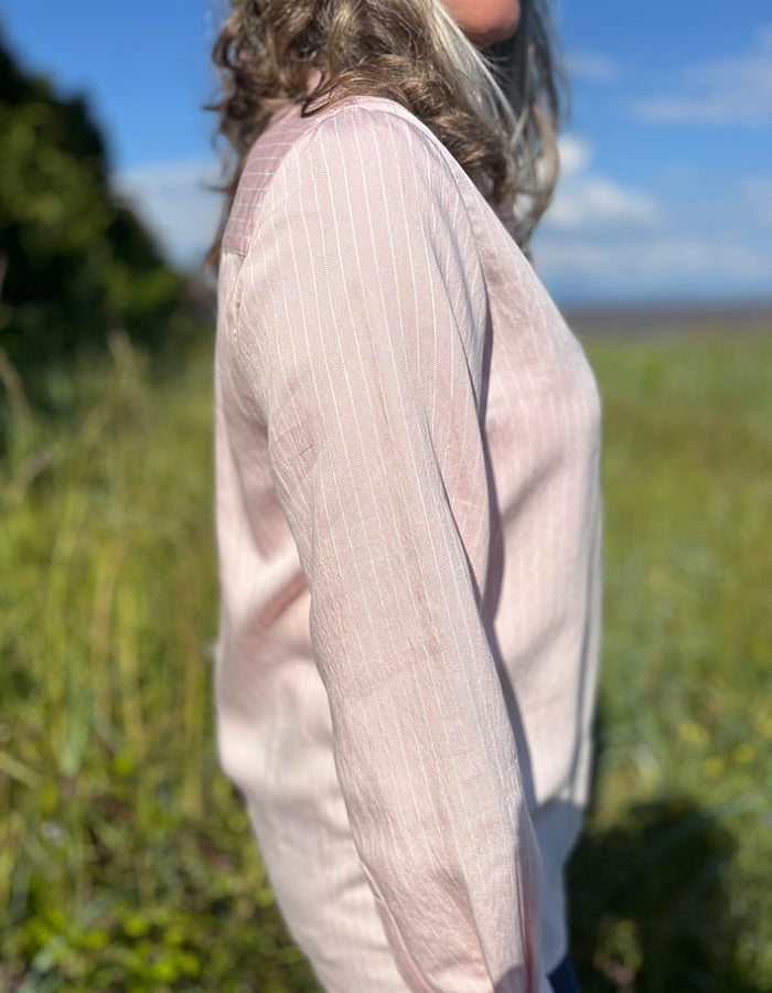 soft baby pink shirt with collar and button down front with white pin stripes