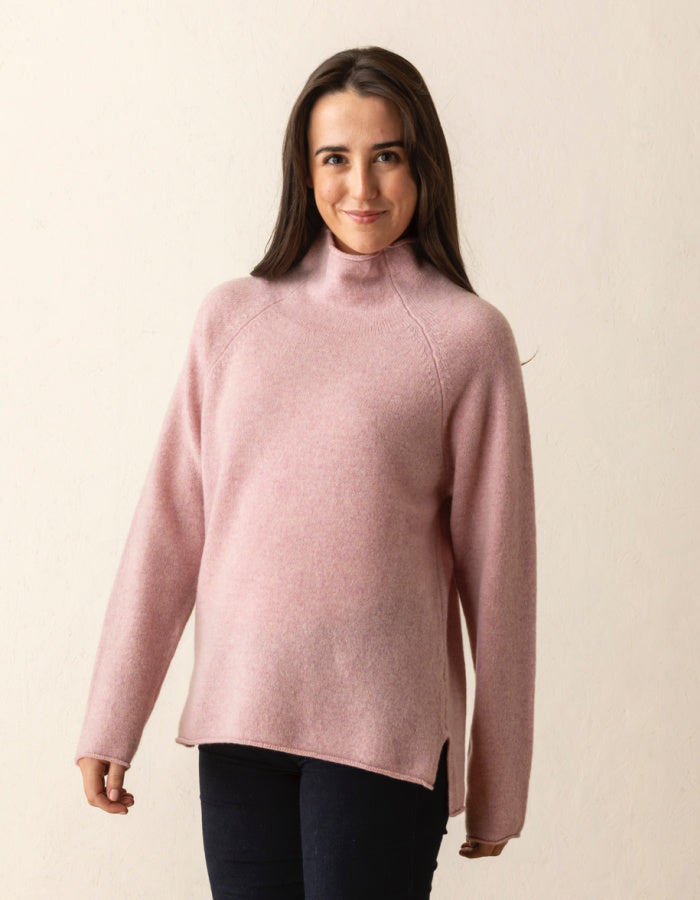 soft pink wool sweater with oversized fit and raglan sleeves and floppy turtle neck