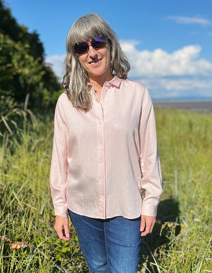 soft baby pink shirt with collar and button down front with white pin stripes