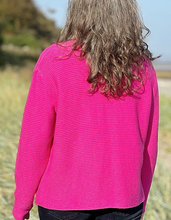 hot pink ribbed turtle neck sweater made from non wool yarns