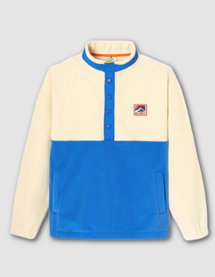 Two-tone beige and blue pullover with a logo on a light gray background