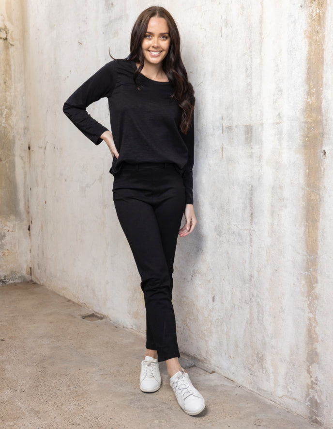 lady wearing black stretch straight leg pull on trousers