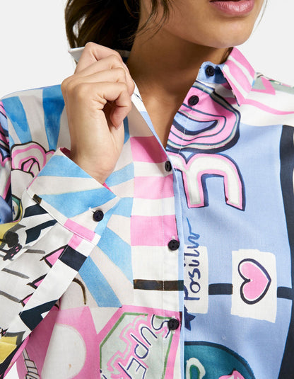 Colorful patterned shirt with graphic designs and text