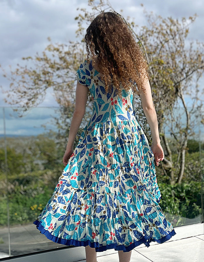 turquoise, blue and red hand block print cotton summer dress with scoop neck and capped sleeves and a full skirt