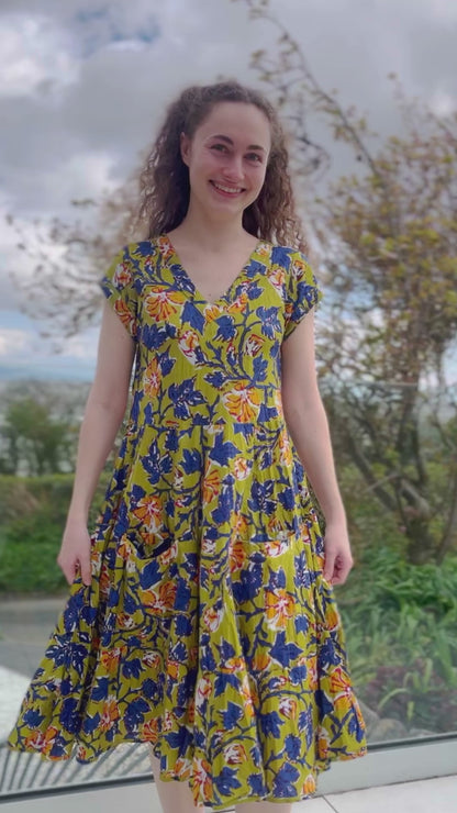 summer cotton midi length dress with capped sleeves and tiered skirt in olive and blue floral design