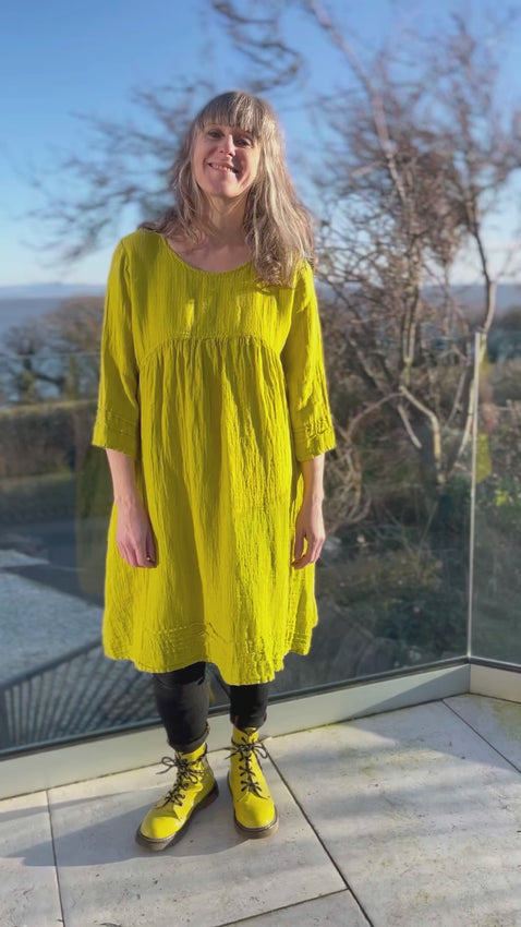 yellow linen loose fit dress with empire line fit and three quarter sleeves and pockets
