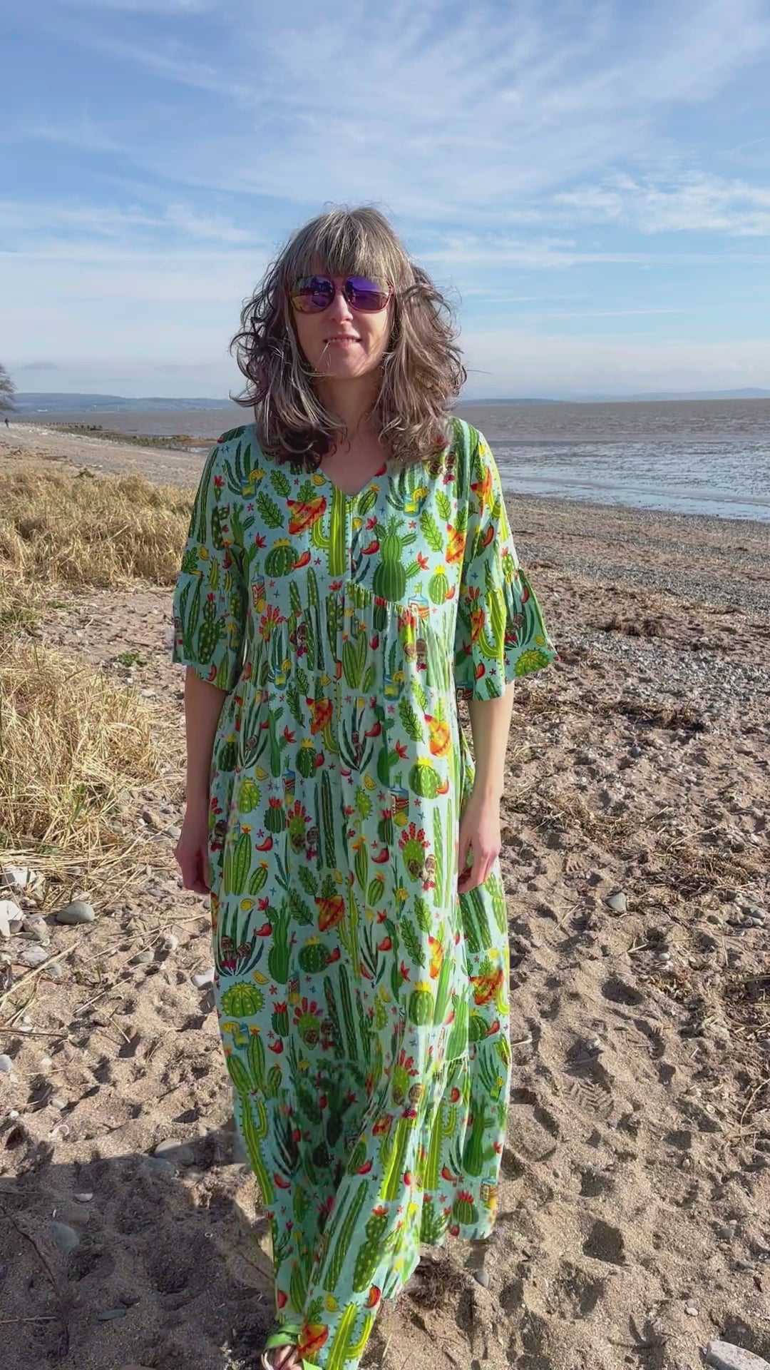 lime green loose fit maxi dress with 3/4 sleeves with frilled edges print includes bright colours cactus, chillis and sombreros