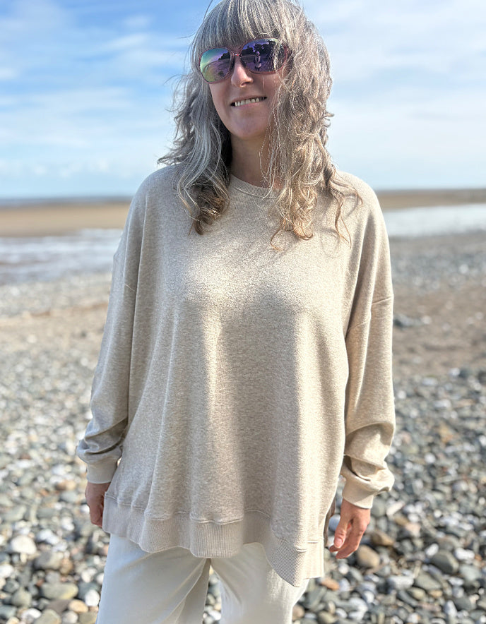 beige oversized sweatshirt and cotton cream trousers