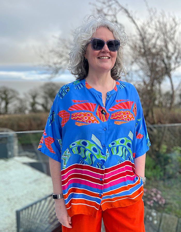 oversized viscose summer shirt with elbow length sleeves and simple round collar with hot colours and an abstract fish print