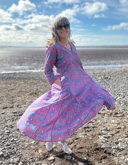 midi length cotton dress with full skirt and pockets and 3/4 length sleeves and V neckline in red and blue hand blocked print