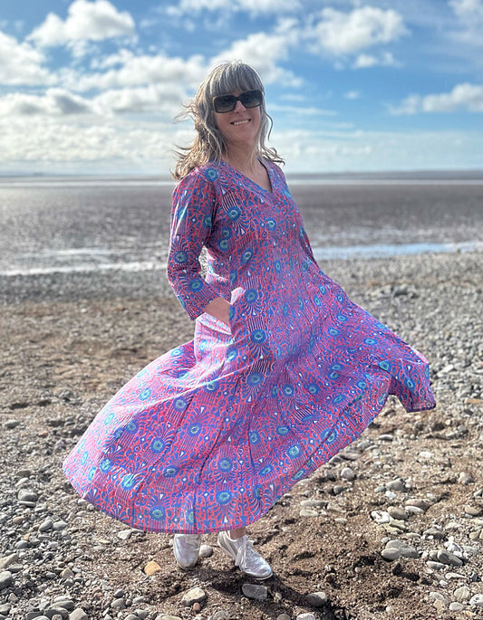 midi length cotton dress with full skirt and pockets and 3/4 length sleeves and V neckline in red and blue hand blocked print