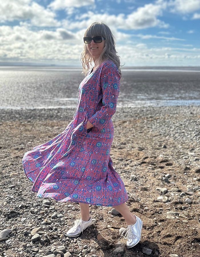 midi length cotton dress with full skirt and pockets and 3/4 length sleeves and V neckline in red and blue hand blocked print