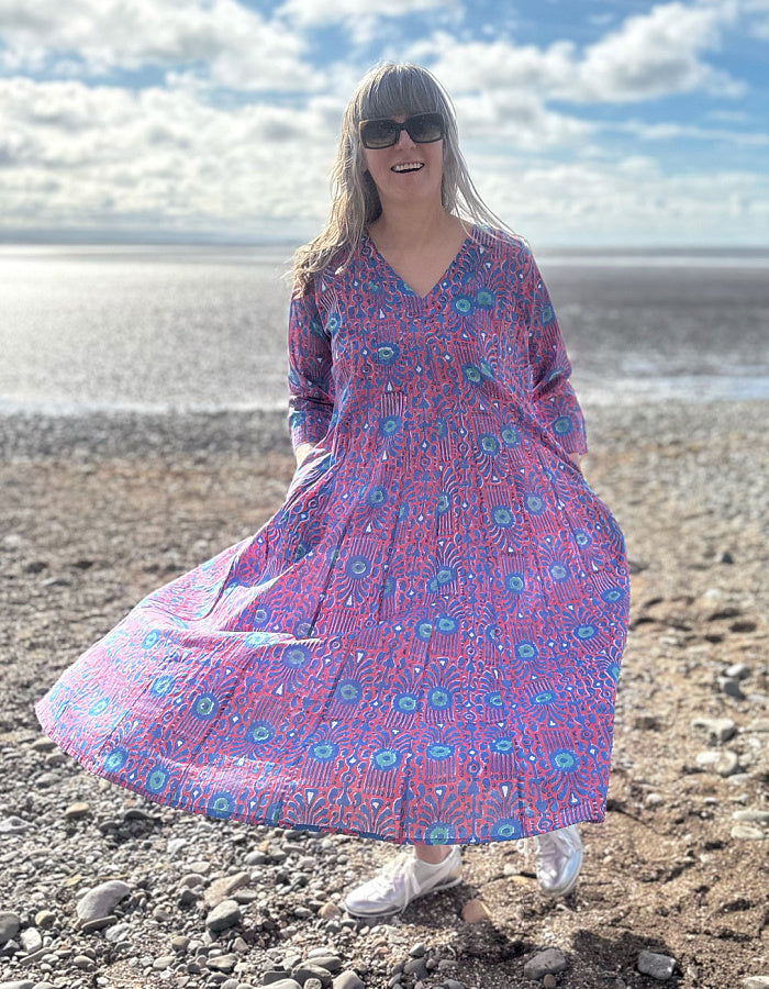 midi length cotton dress with full skirt and pockets and 3/4 length sleeves and V neckline in red and blue hand blocked print