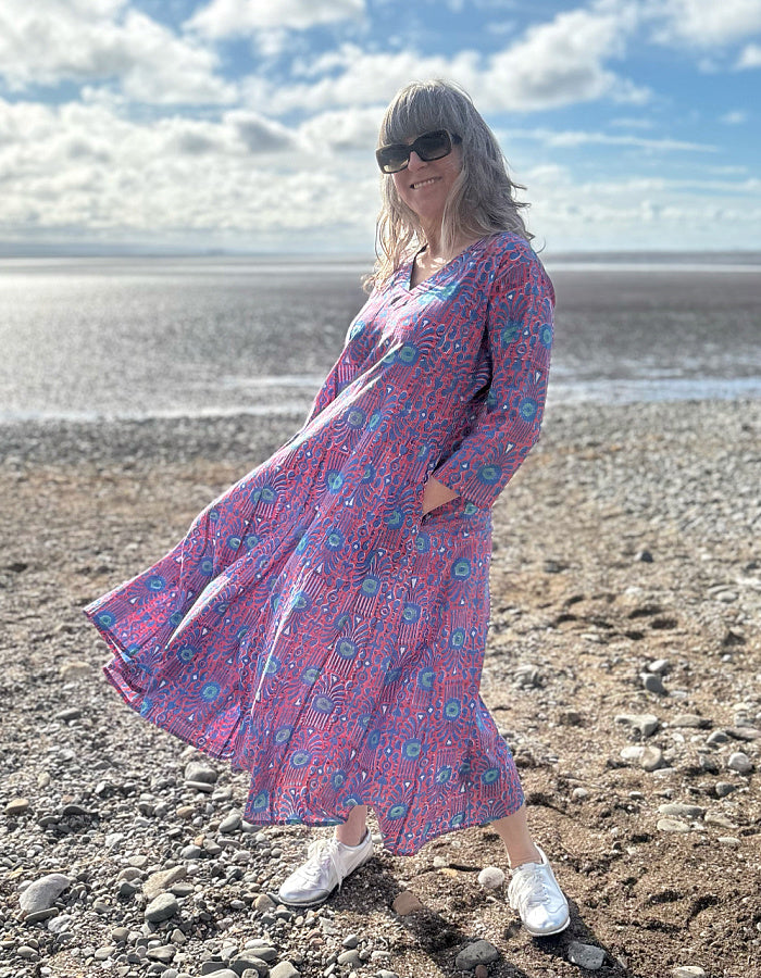midi length cotton dress with full skirt and pockets and 3/4 length sleeves and V neckline in red and blue hand blocked print