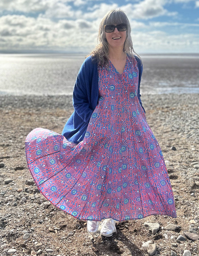 midi length cotton dress with full skirt and pockets and 3/4 length sleeves and V neckline in red and blue hand blocked print