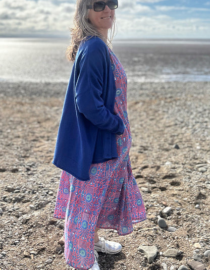 midi length cotton dress with full skirt and pockets and 3/4 length sleeves and V neckline in red and blue hand blocked print