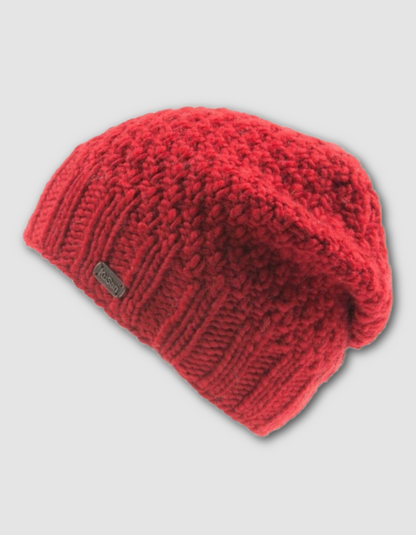 Red knitted beanie on a light gray background