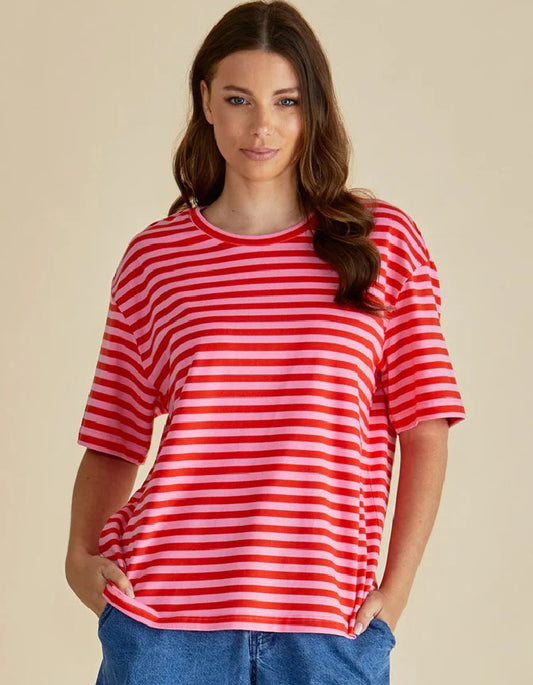 Woman wearing a red and white striped shirt against a beige background