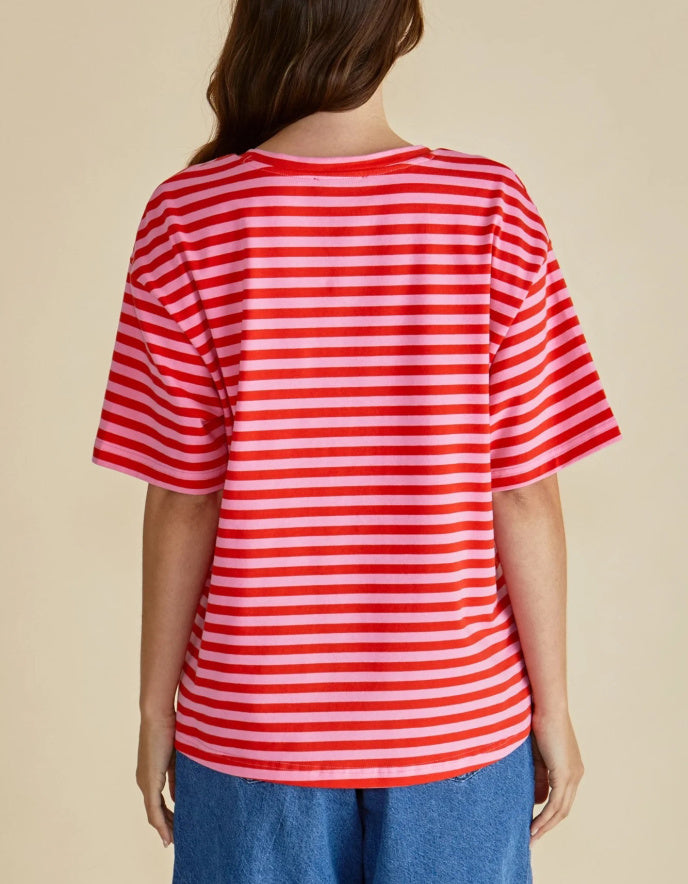 Person wearing a red and white striped shirt on a beige background