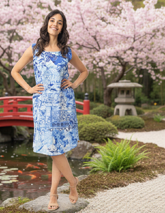 woman wearing a reversible sleeveless shift dress in an outdoor Japanese setting
