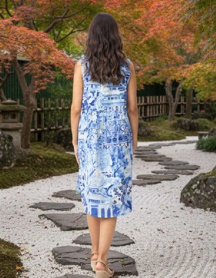 woman wearing a reversible sleeveless shift dress in an outdoor Japanese setting