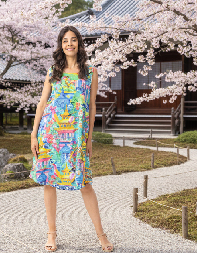 woman wearing a reversible sleeveless shift dress in an outdoor Japanese setting