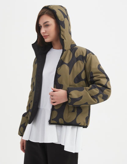 Woman wearing a camouflage olive and black reversible puffer jacket on a white background