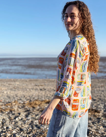 Person wearing a colorful patterned shirt on a beach