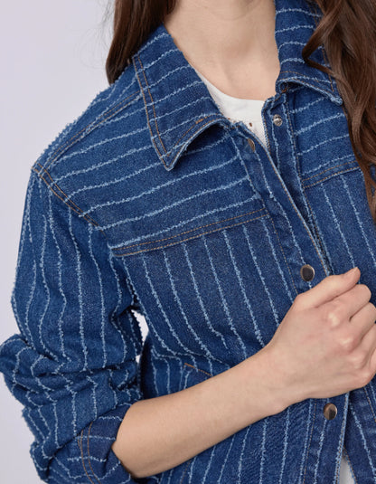 Close-up of a person wearing a blue pinstripe denim jacket on a light gray background