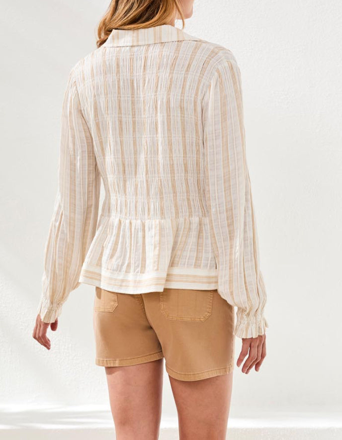 Person wearing a striped shirt and beige shorts on a white background