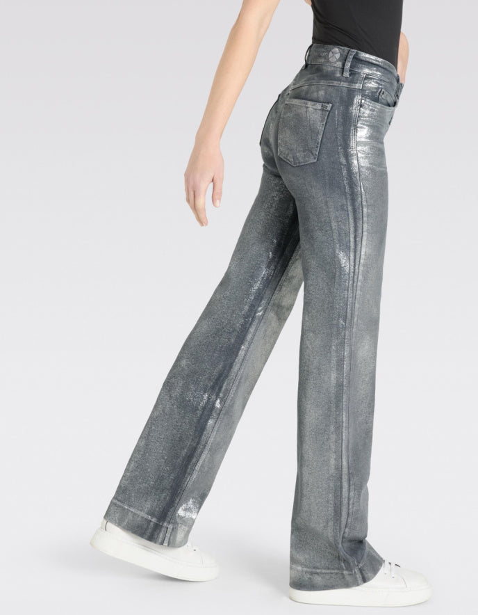 Person wearing gray flared jeans on a white background