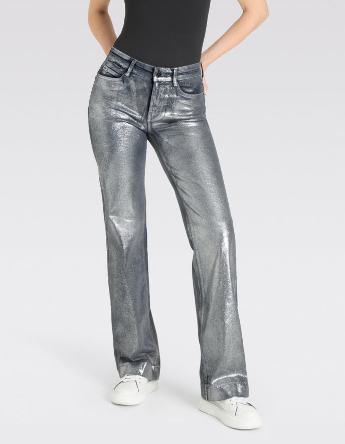 Person wearing silver metallic jeans on a white background