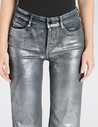 Silver metallic jeans worn by a person on a white background