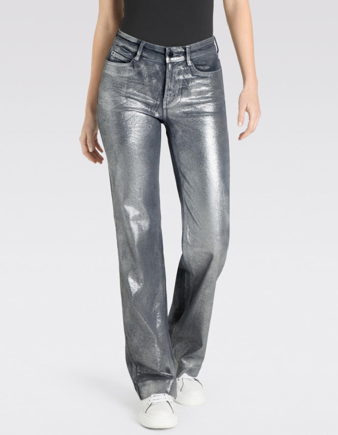 Person wearing metallic silver jeans on a white background