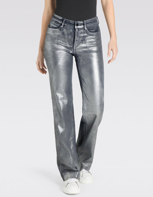 Person wearing metallic silver jeans on a white background